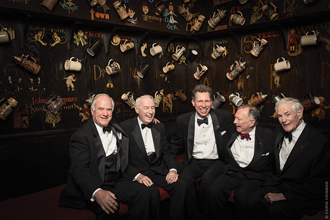 Steve Goff, John Hackney, Bryan Margerum, Mike Huber and Bruce Mainwaring share a laugh in the Grille Room of the Mask & Wig clubhouse. The club has owned the building on Quince Street in Center City—which is listed on the historic register—since 1894. The caricatures on the walls are of members of the Graduate Club, with their accompanying drinking mugs.