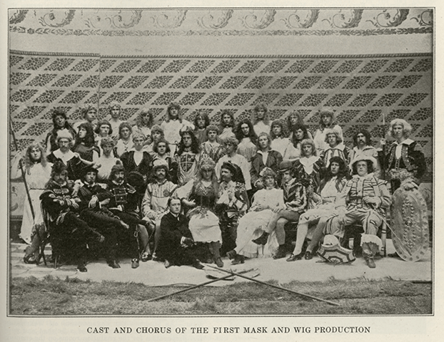 Cast photo for Mask & Wig’s first production, Lurline, in 1889. According to a notice in the April 14, 1922 issue of the Gazette—where we found it reproduced to illustrate a story on that year’s show, Tell Tales—the role of “Sir Rupert, the Knight” was played by club founder Clayton Fotterall McMichael C1891. (We’re guessing he’s the one with the shield on his chest.)