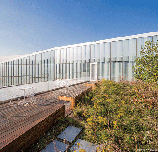 An upper-floor deck and garden area provide an outdoor escape.