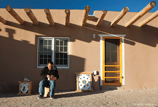 Justin Aguino, a member of the Ohkay Owingeh tribe, in front of his newly rehabilitated home in Owe’neh Bupingeh. 