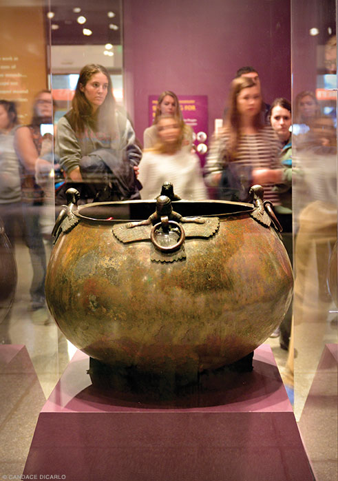 Large cauldron with siren and demon attachments—probably intended to inspire awe and offer protection to the deceased—used to store liquids for the funerary feast.