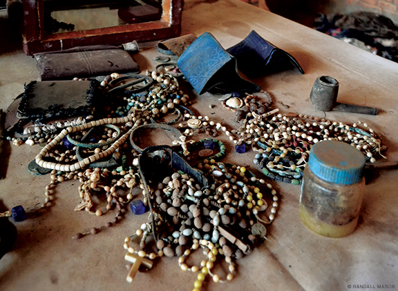 Besides clothes, materials to be conserved include rosary beads and other objects shown here on the altar in the church.