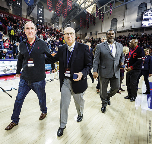 Weinhauer flanked by former student manager Peter Levy W’82, left, and Tim Smith. 