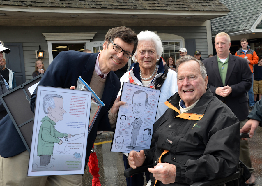 Robert Carley poses with George H. W. Bush and Barbara Bush, holding two illustrations