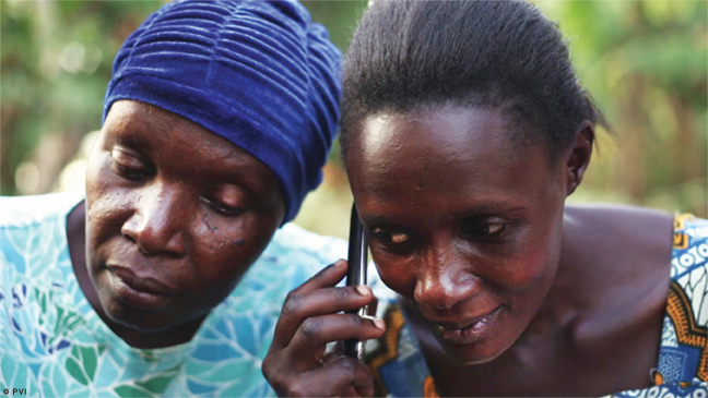 Photo showing two people listening to an adventure game on a cell phone.