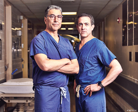 Photo of David Langer and John Boockvar in scrubs.