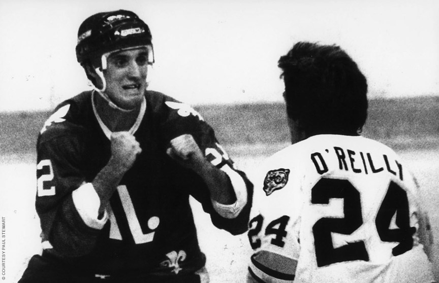 Photo of hockey player Paul Stewart gearing up for a fight on the ice.