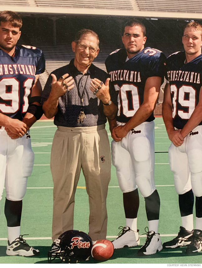 Photo of Coach Lake showing off his Ivy League championship rings.