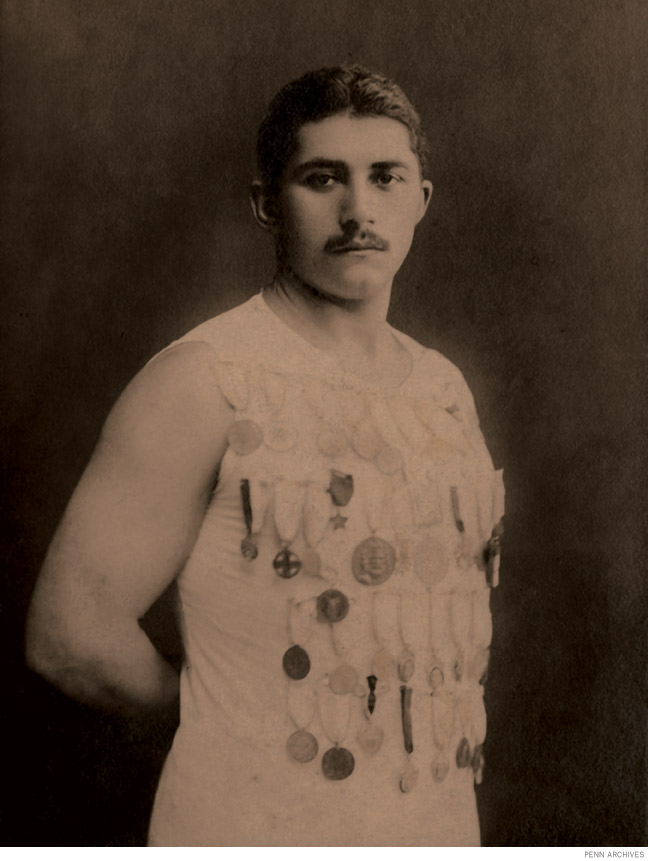 Photo of Michail “Mike” Dorizas wearing numerous medals 