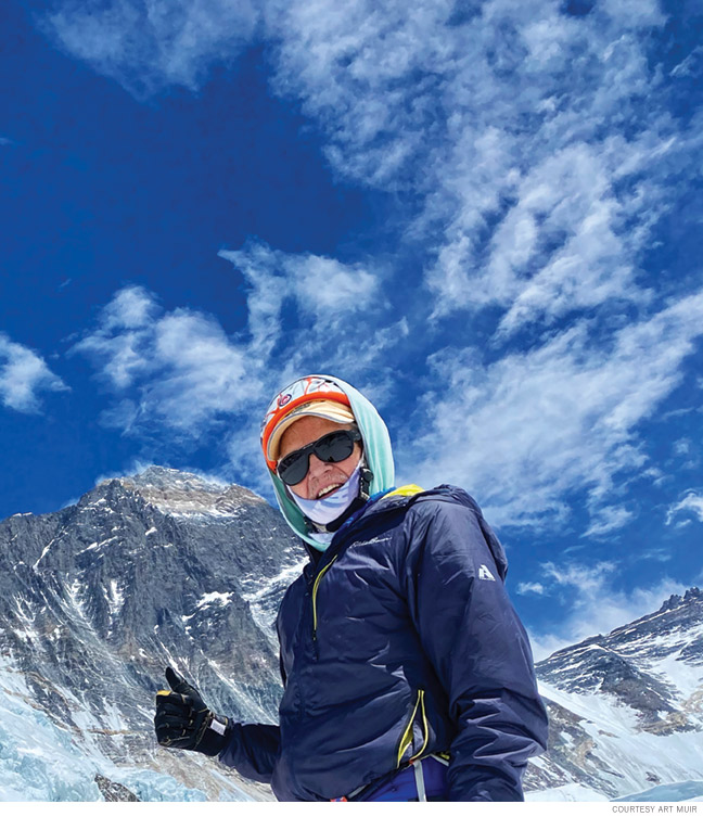 Photo of Art Muir giving the thumbs up on his way up the mountain