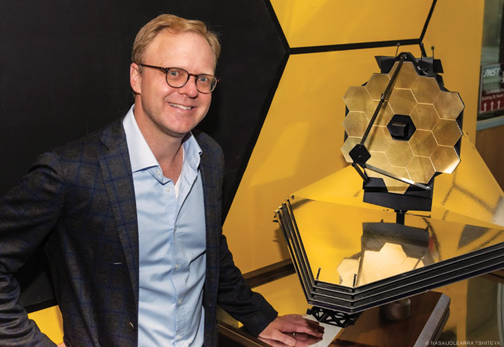 Photo of Mike McElwain with a miniature version of the James Webb Space Telescope.