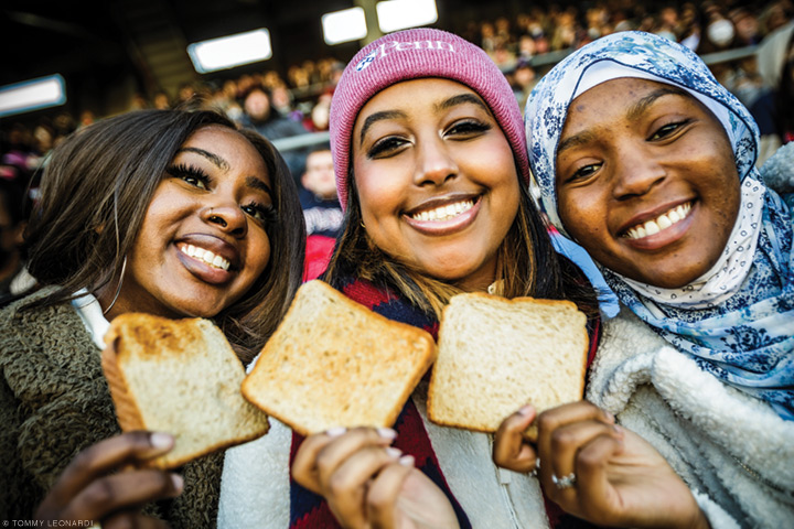 Photo of students holding toast at Penn's homecoming football game.