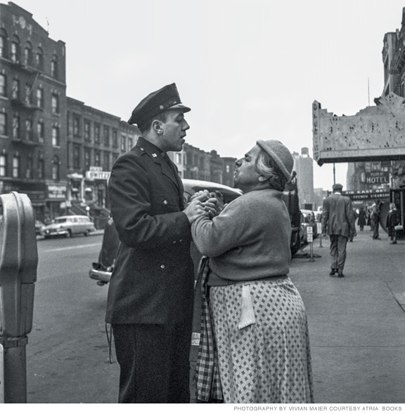 Photo of policeman restraining the hands of a woman.