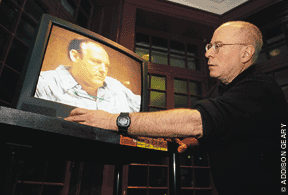 Photo of Andy Wolk staring at tv screen